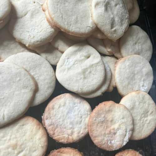 sugar cookies stacked and scattered around