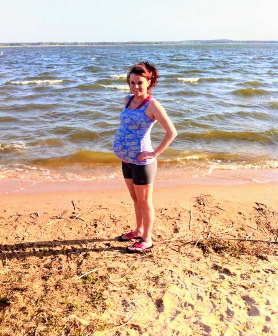 pregnant sober mom standing on beach