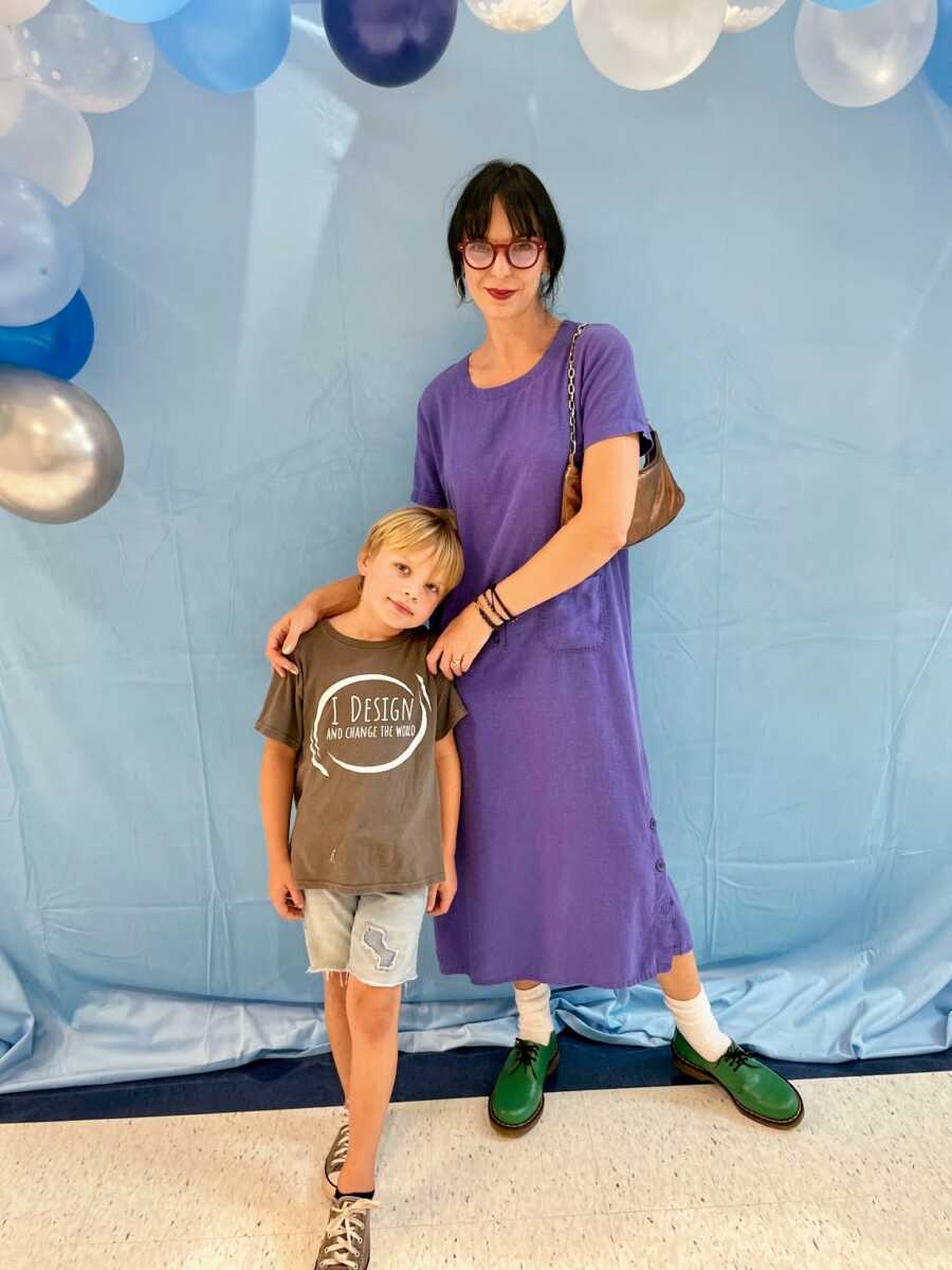 sober mother with son on first day of first grade