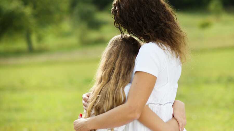 stepmom and stepdaughter hugging each other