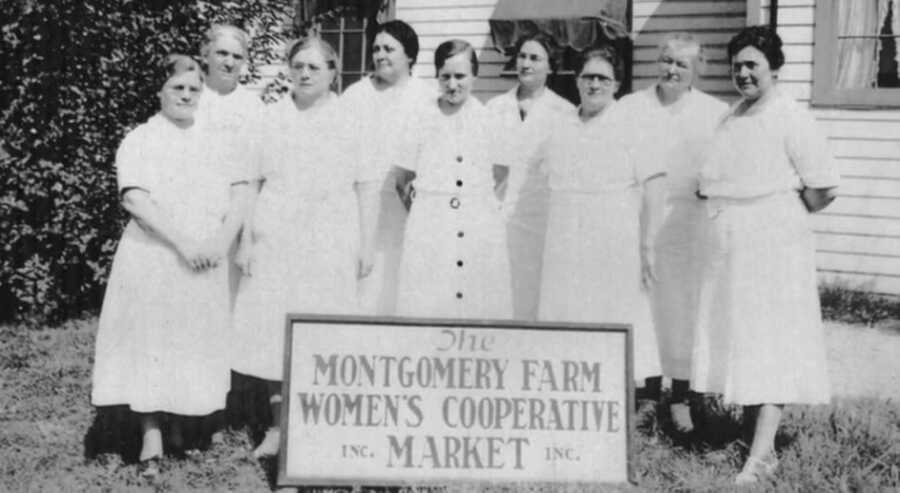 The women of the Montgomery Farm Womens Market wearing white dresses