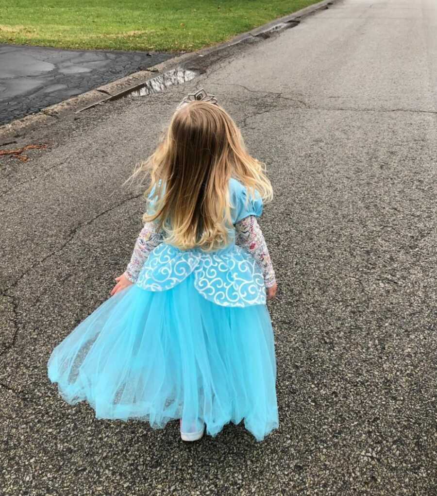 Toddler daughter dressed in a blue princess gown and tiara