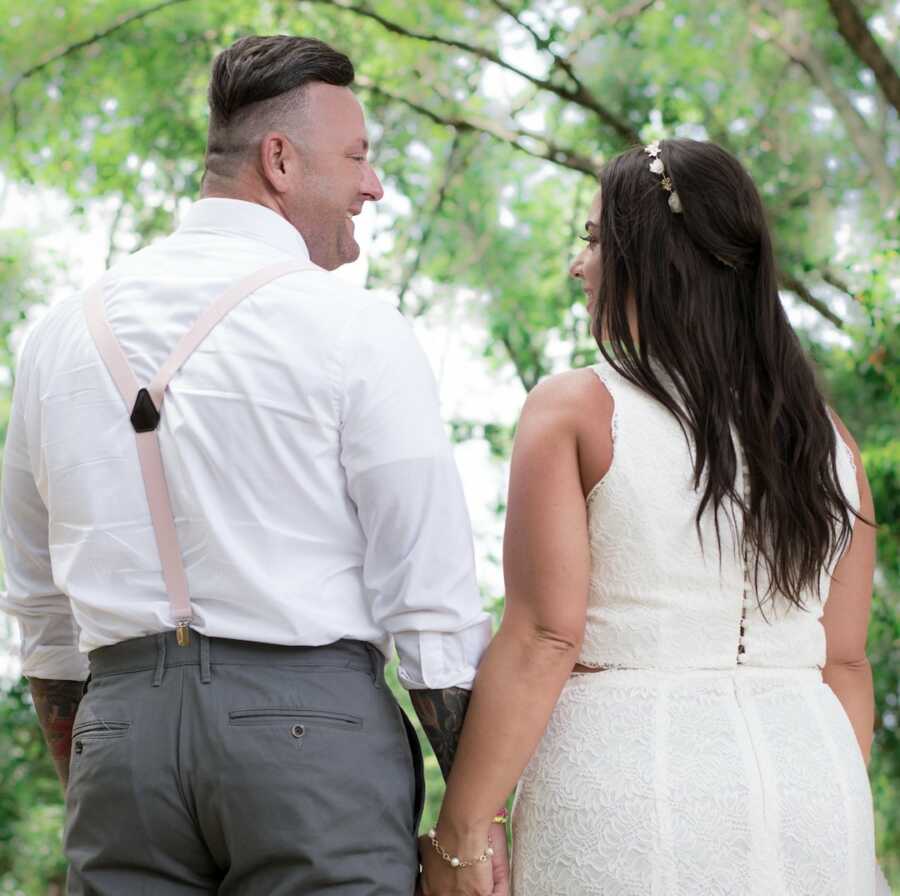 trauma survivor stands with her new husband on their wedding day