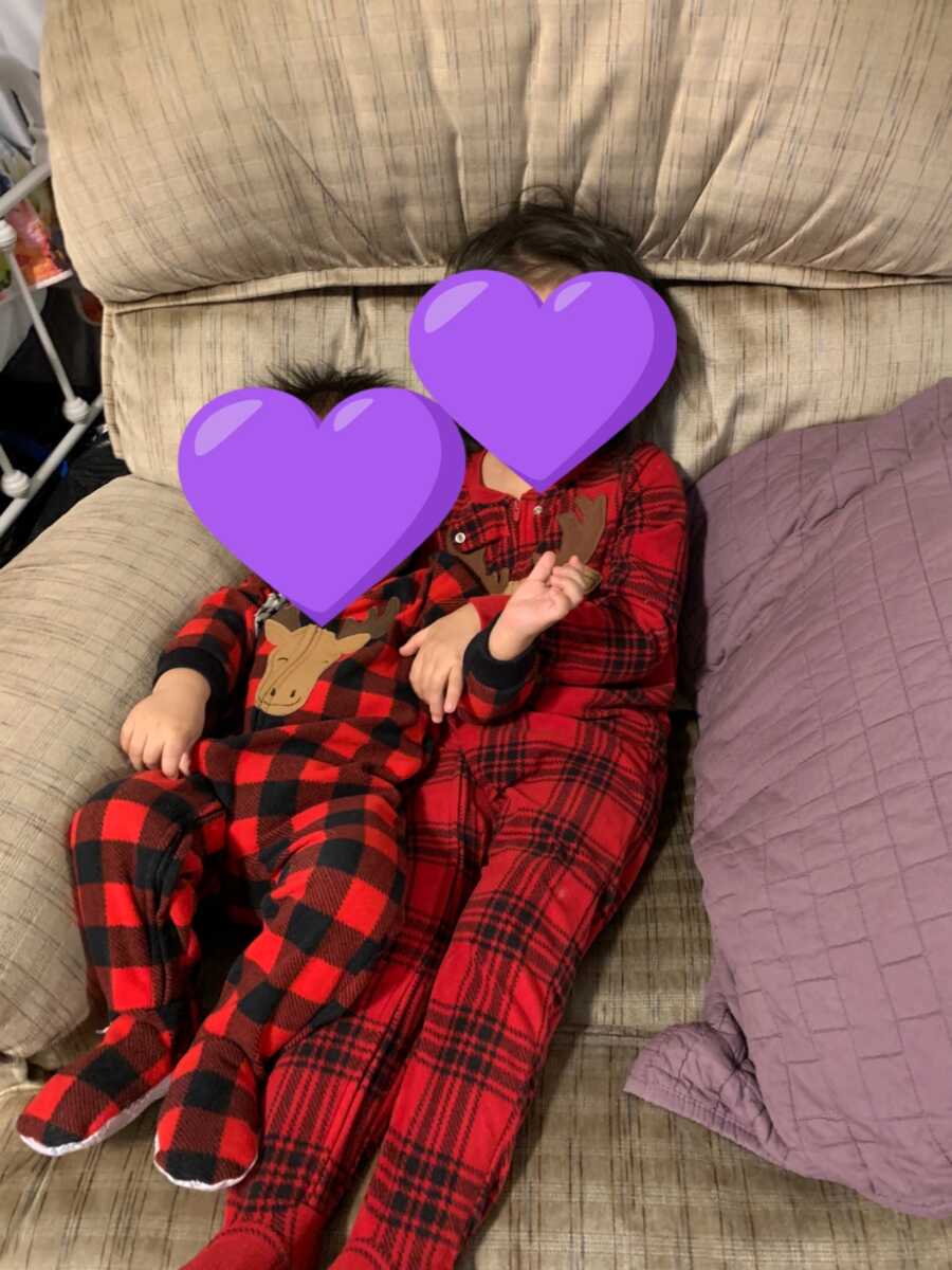 two foster kids laying with matching red and black pjs