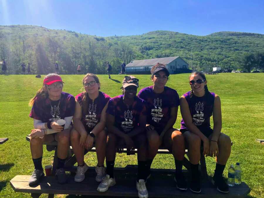 girl with vitiligo sits outside with classmates in long sleeves