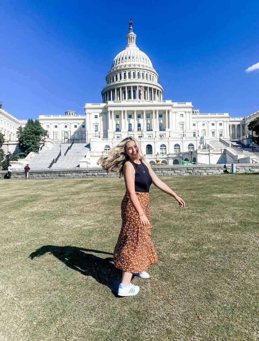 woman in front of state capitol building