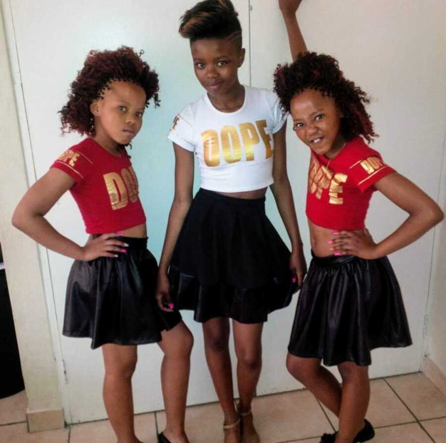 woman with vitiligo and twin sisters in crop tops and black skirts
