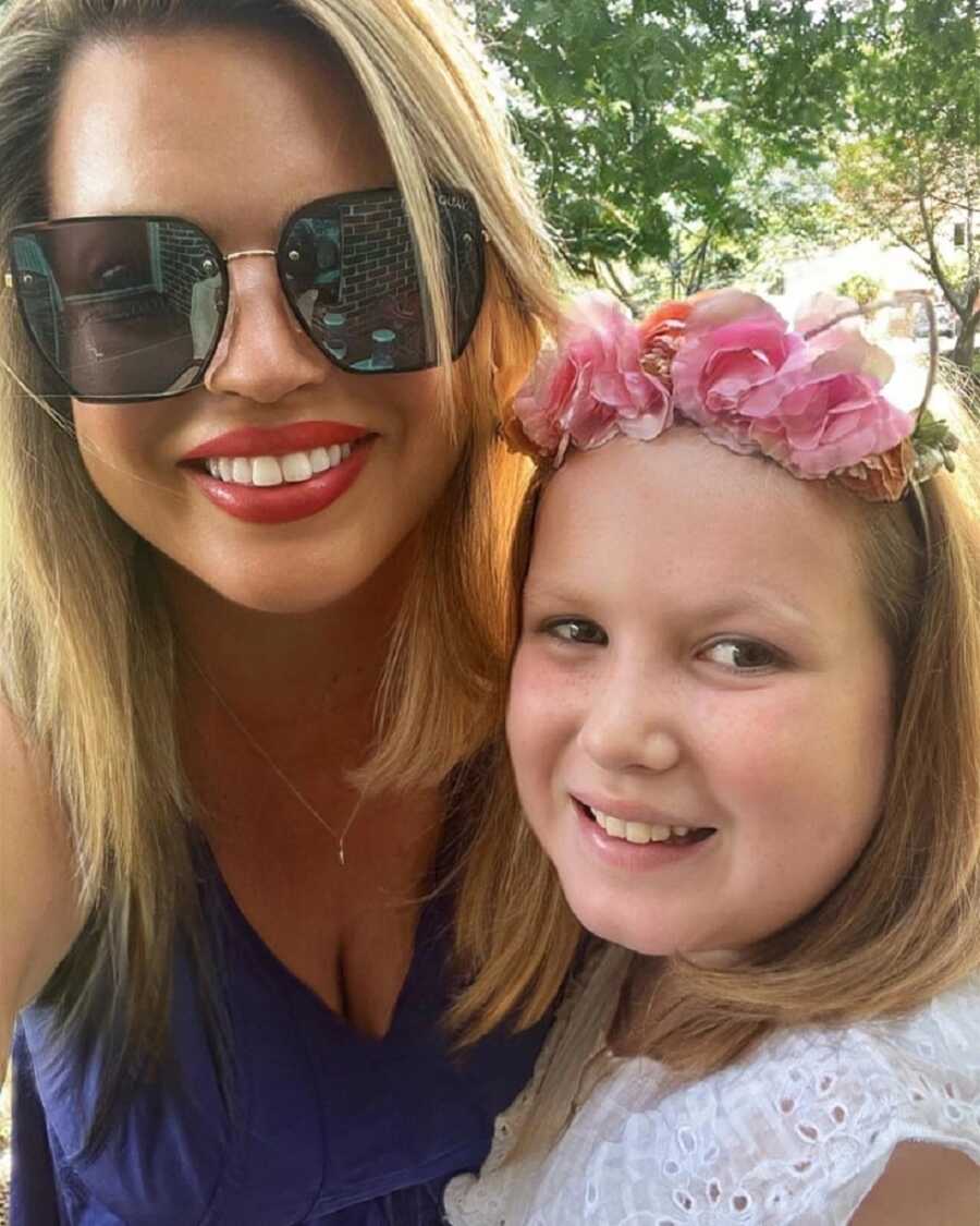 young widow takes selfie with daughter