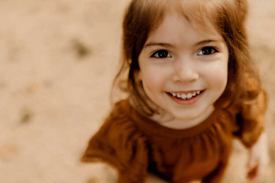 adopted daughter looks into camera smiling