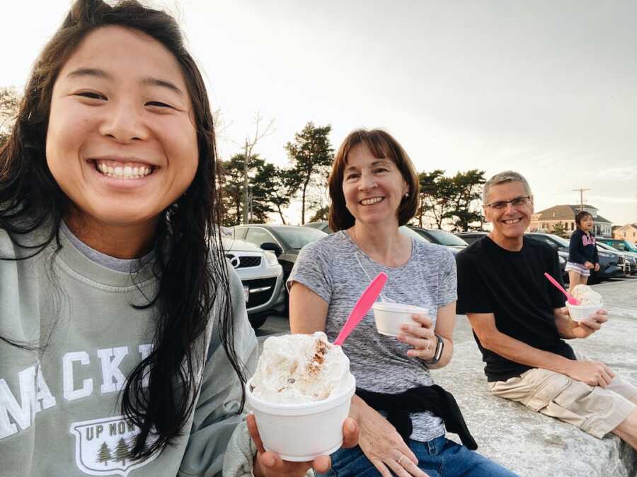 Korean adoptee eating ice cream with her adoptive parents
