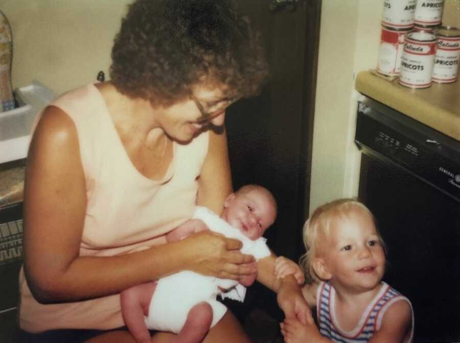 old photo of adoptive mom holding adoptee newborn