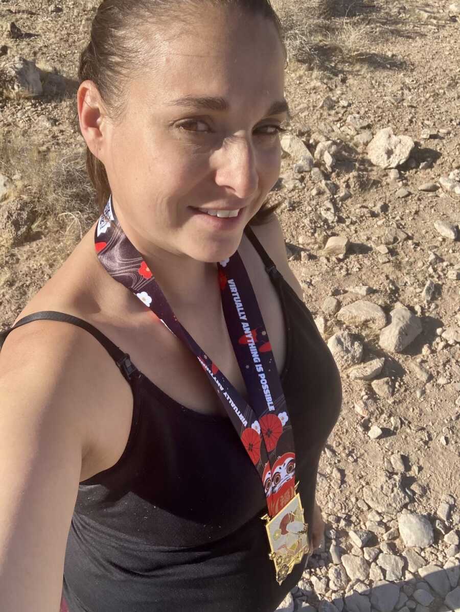 asthma warrior takes a selfie wearing a medal from completing a race