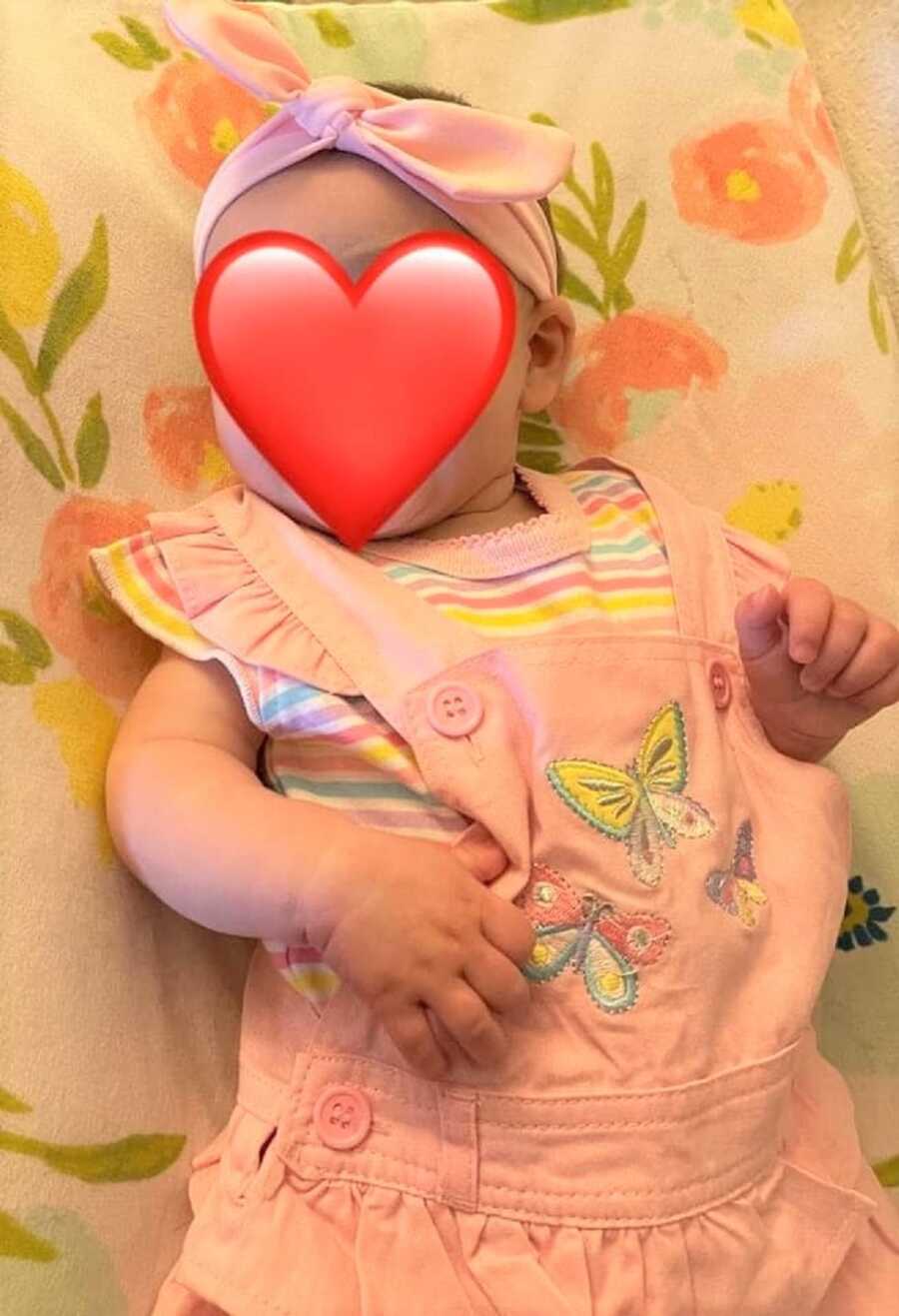 foster baby girl in pink overall dress