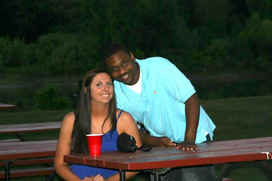 woman with red solo cup sitting next to her boyfriend