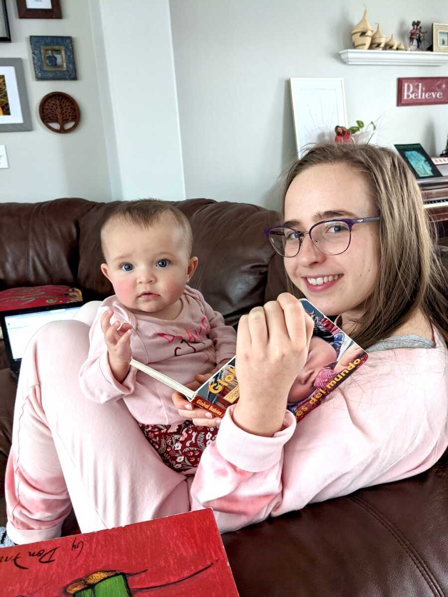 biological daughter holding adopted sister