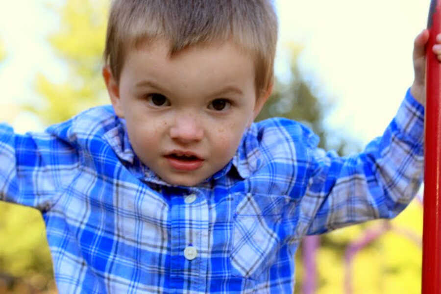 boy in foster care wearing a plaid shirt