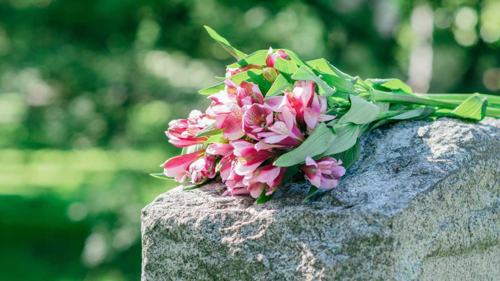 flowers resting on the top of a child's gravestone