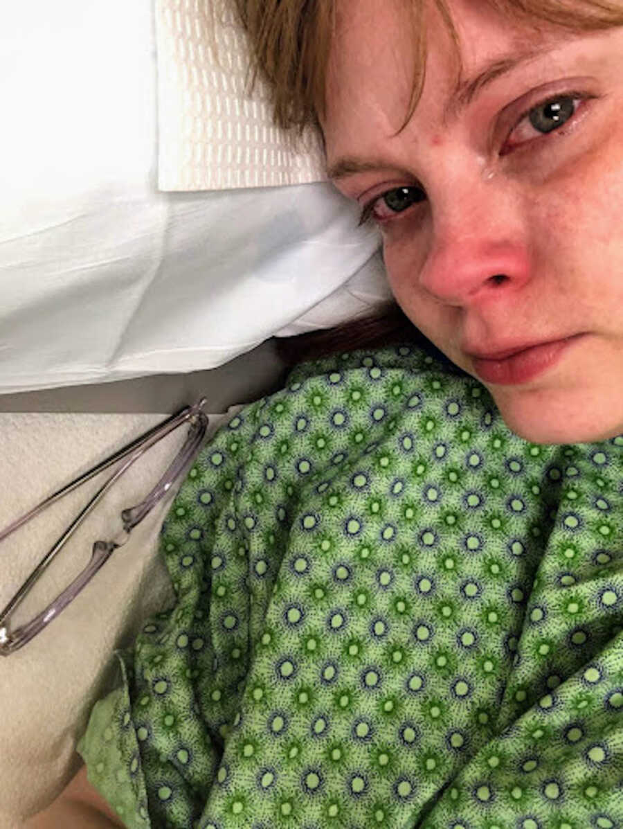 chronic illness warrior crying while laying in hospital bed