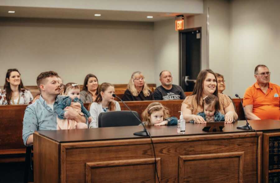 family gathered at court for adoption of daughter into family