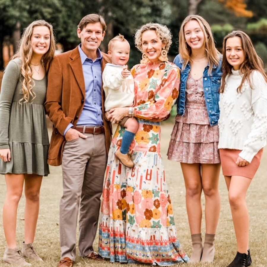 Family photo with older daughters and toddler with down syndrome 