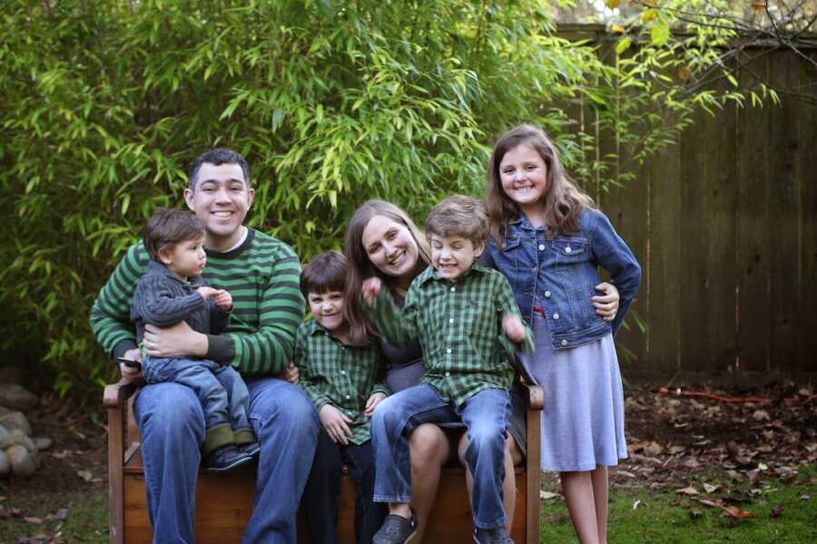 family of six grouped together outside for Christmas card