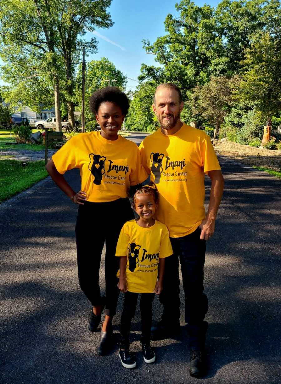 kenyan wife and american husband with daughter wearing yellow imani shelter shirts
