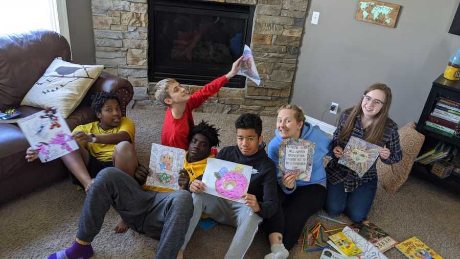 group of siblings sitting on ground coloring together