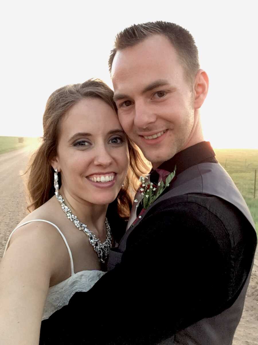 husband and wife take a selfie together on their wedding day