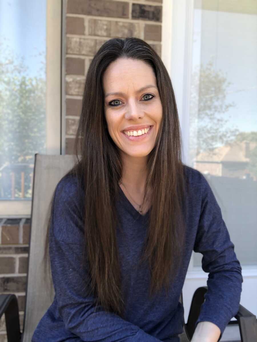 loss mom smiling while sitting in chair outside