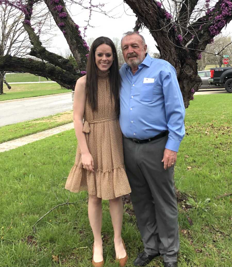 loss mom standing with a family member in front of a tree