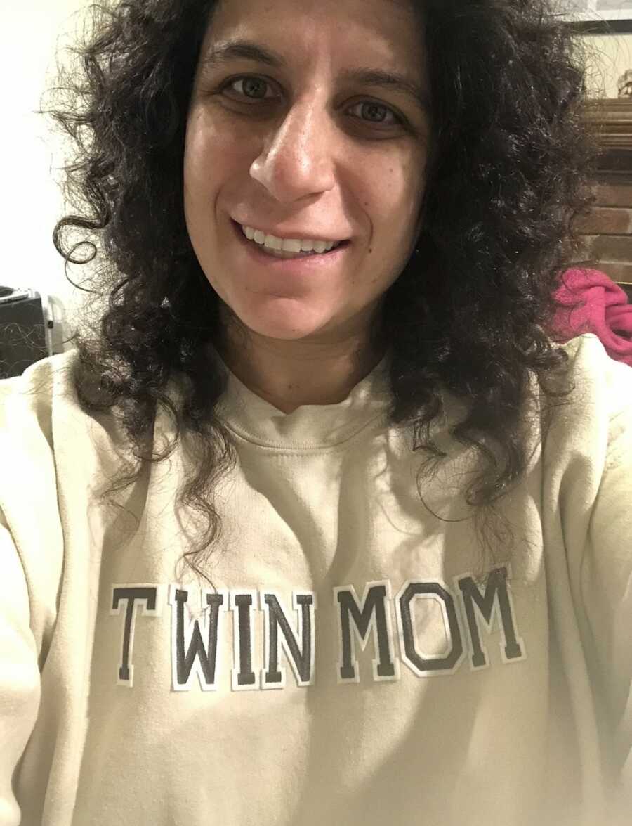 mom wearing "twin mom" crewneck taking a selfie