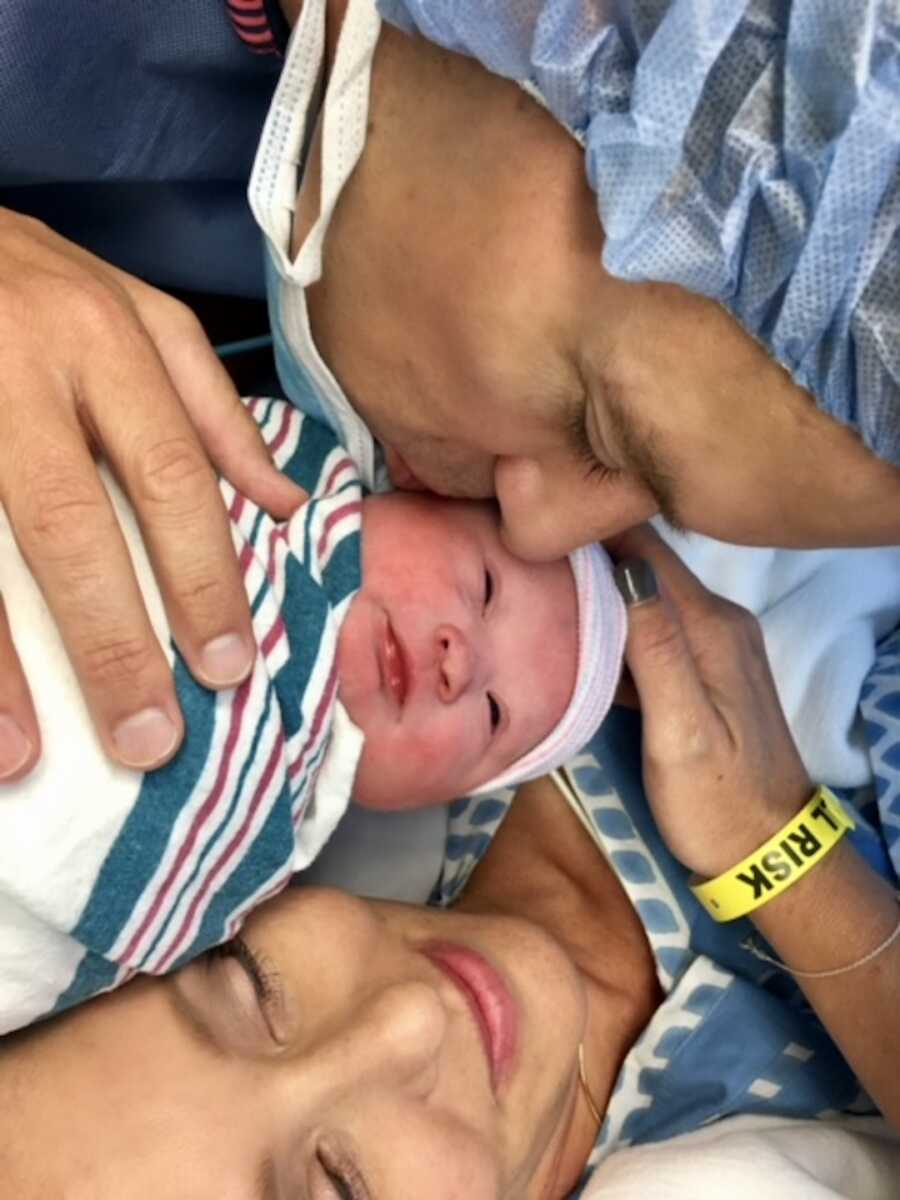 Mom and dad hold newborn baby with down syndrome 