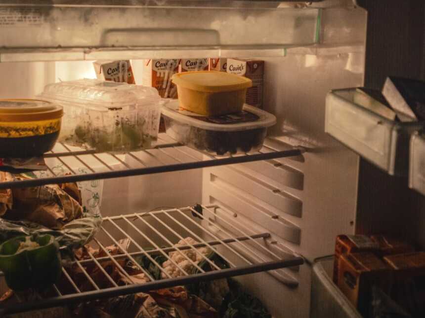 Open refrigerator with leftover food containers