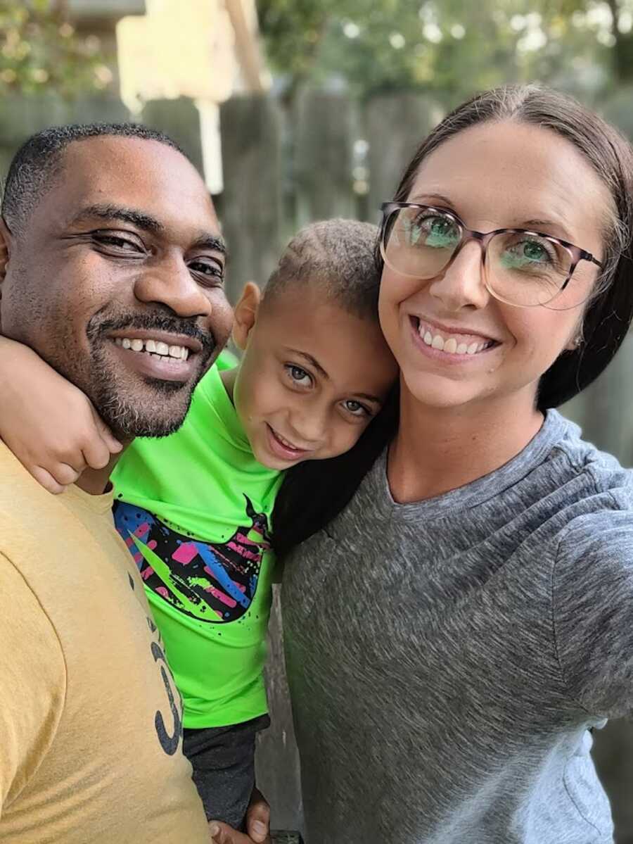 Mom takes selfie with her son and husband, all are smiling