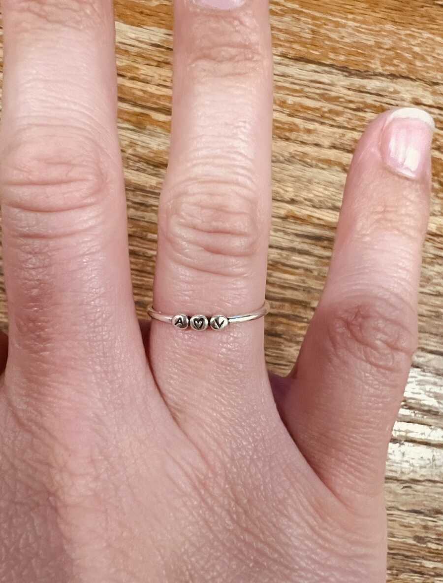 twin mom wearing ring with babies' initials