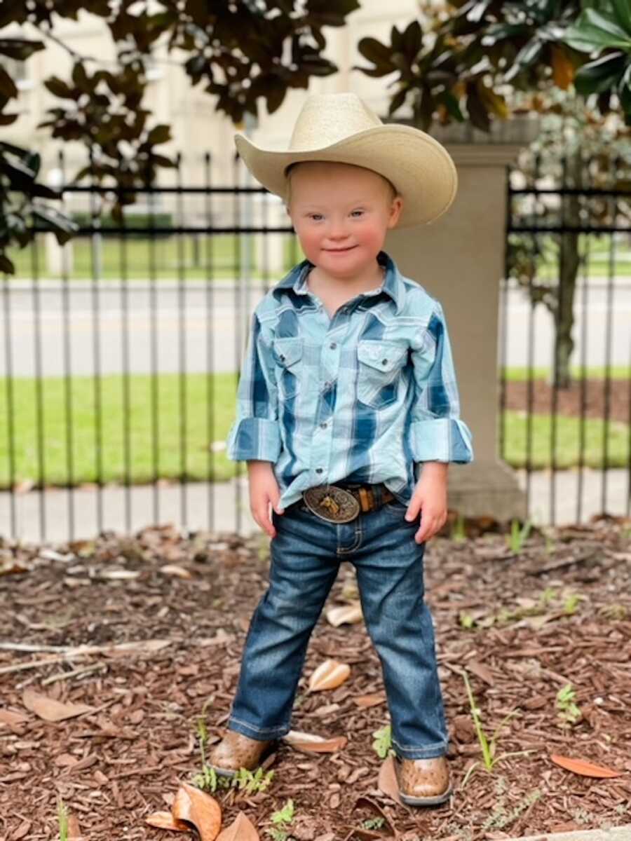 Toddler with down syndrome dressed up as a cowboy