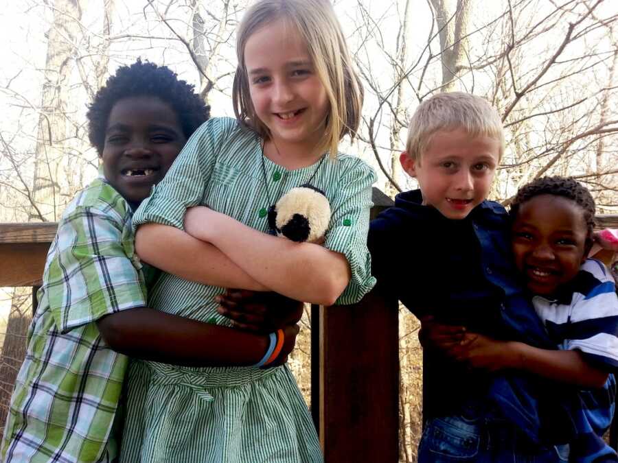 adoptive siblings hug biological siblings