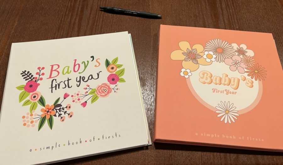 two baby's first year books on table with pen