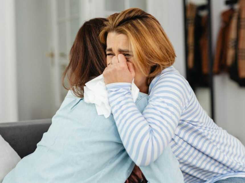 Woman hugging crying friend