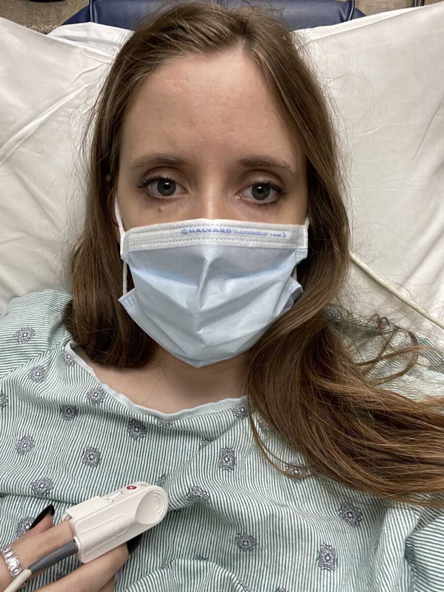 woman with lyme in hospital bed wearing mask