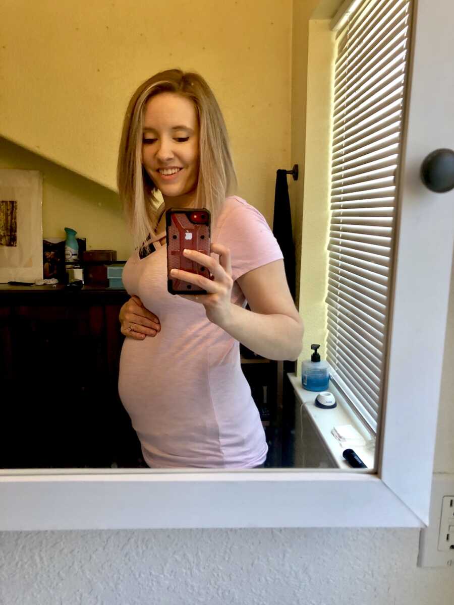 woman with lyme disease shows off bump while pregnant