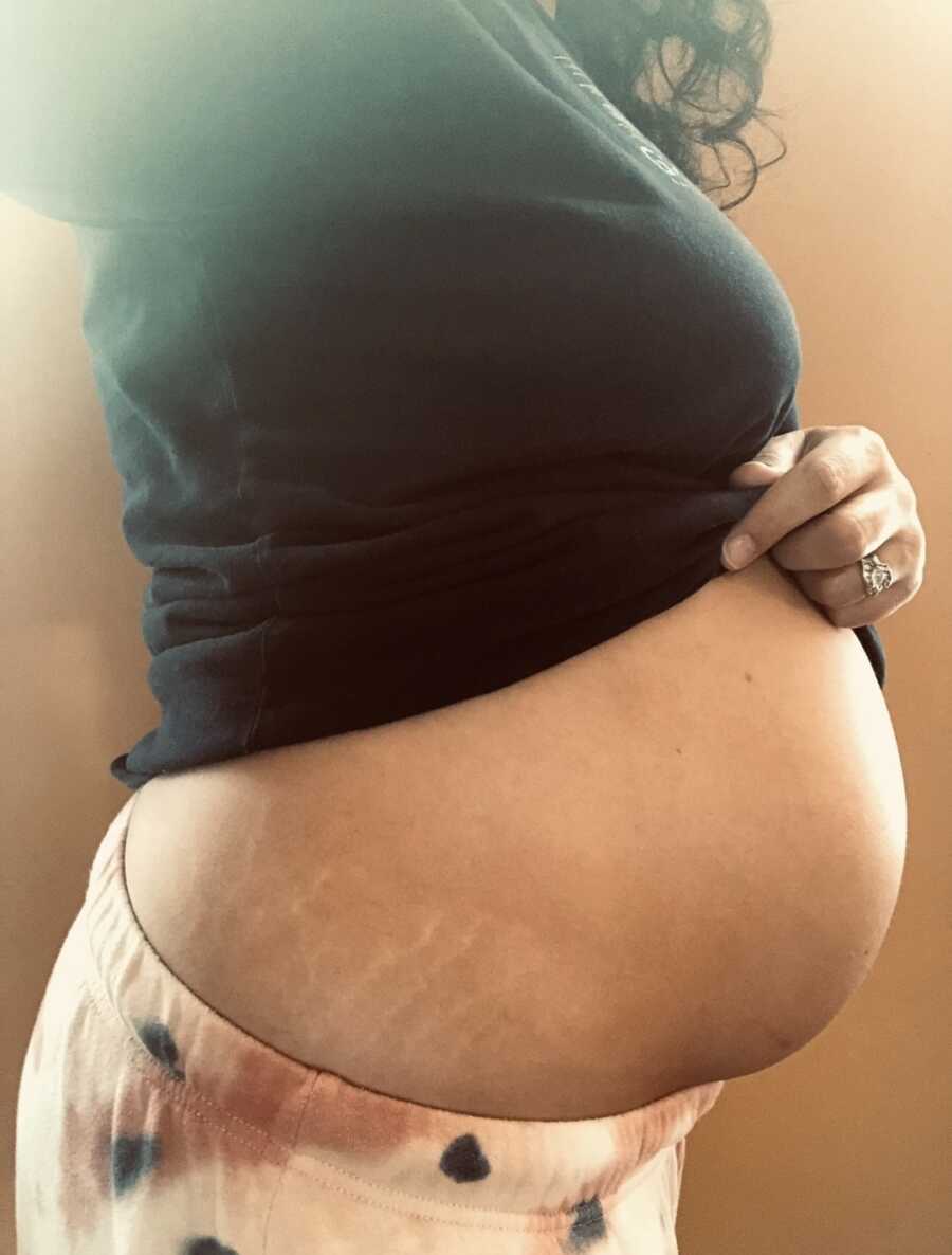 woman showing off her belly bump with twins