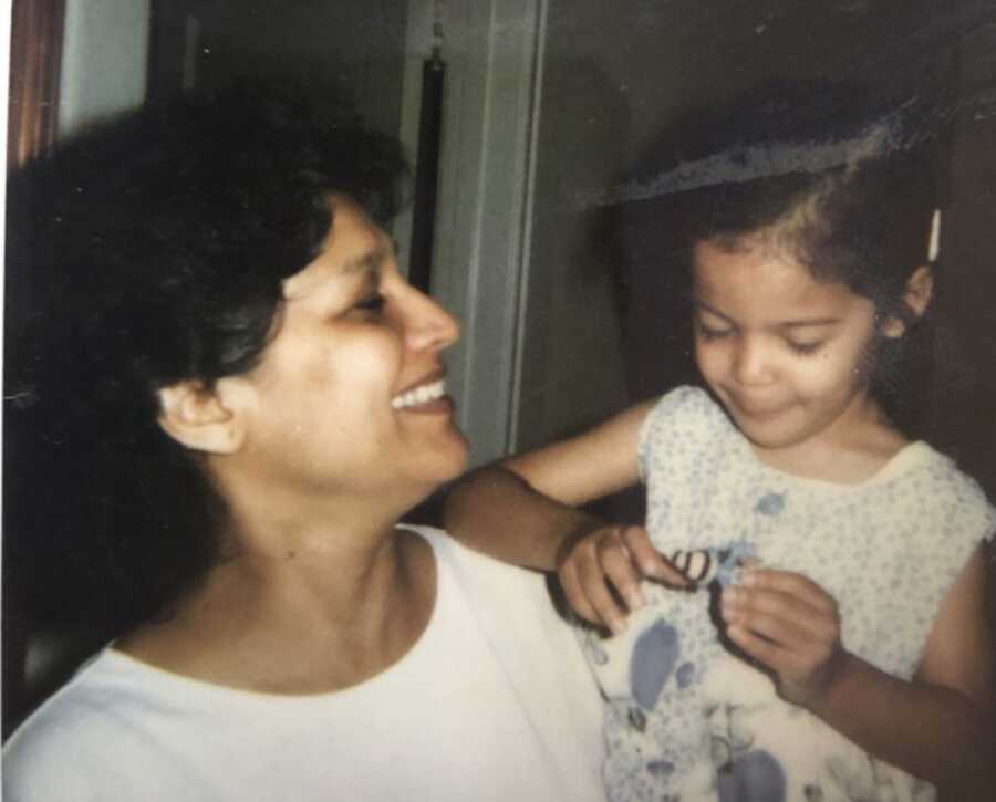 young girl being held by her mom