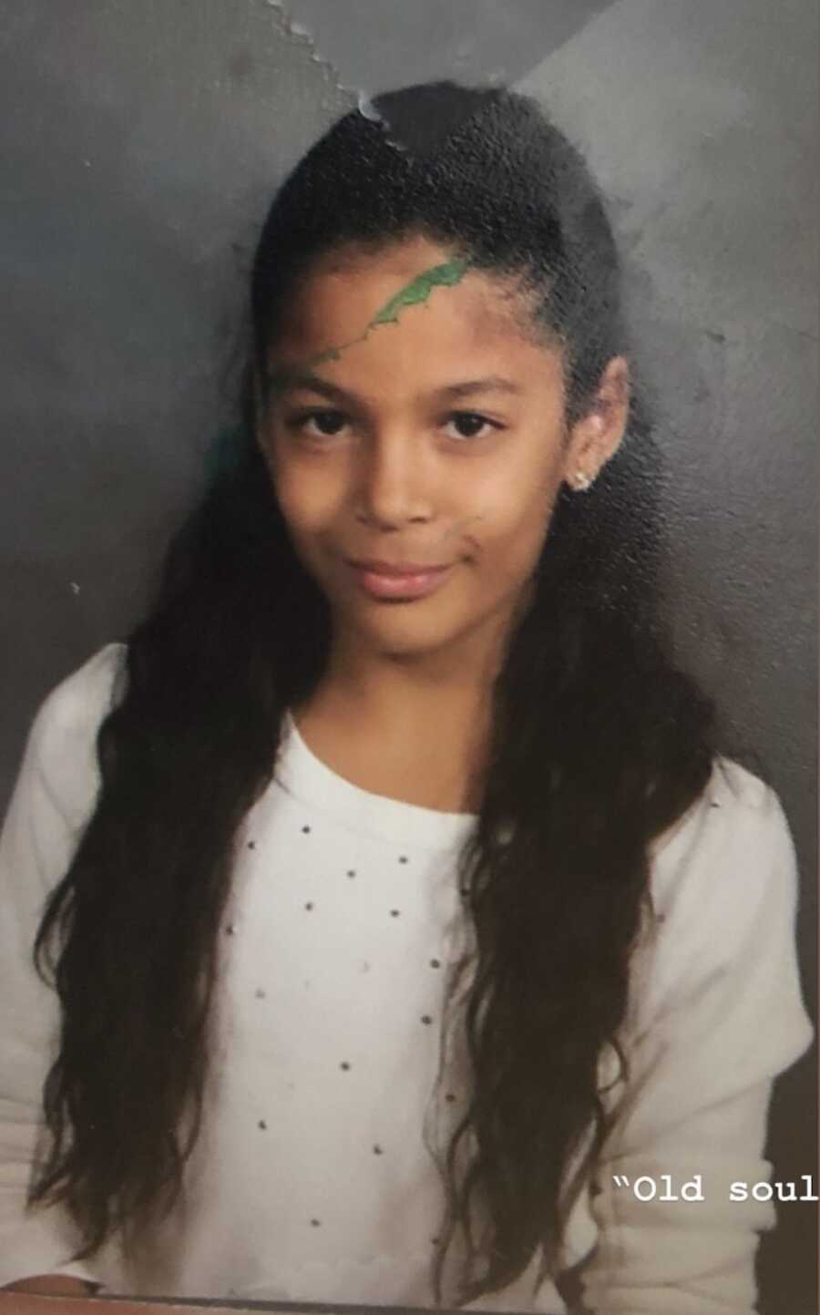 young girl sitting for school photos