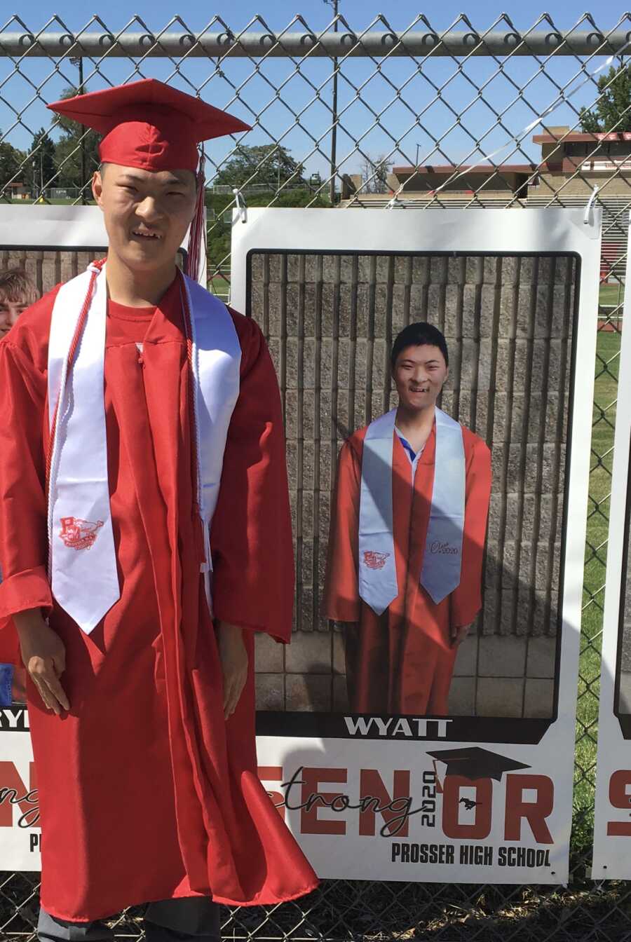 FASD survivor wearing red cap and gown graduating highschool