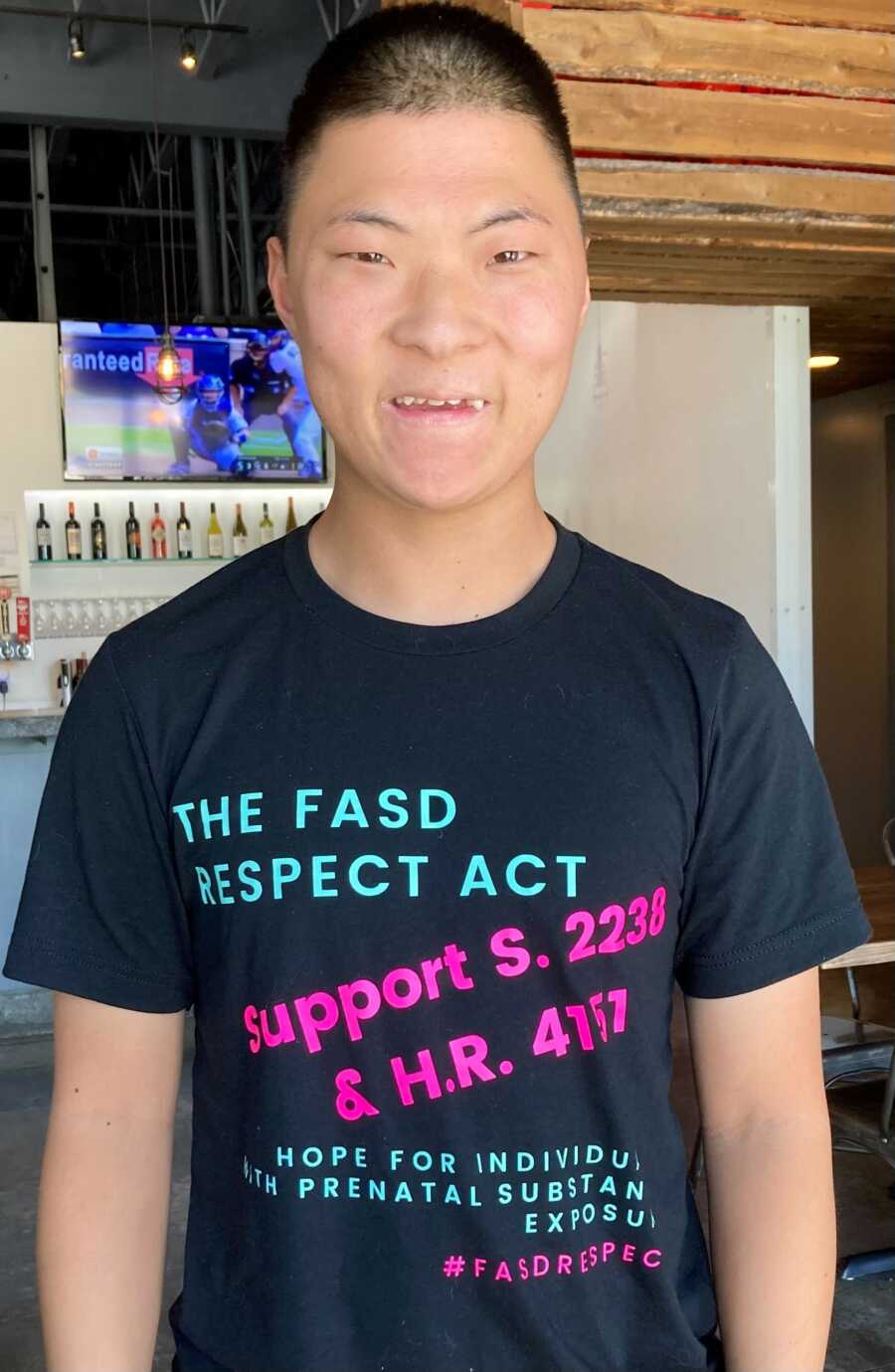 FASD survivor wearing a black FASD awareness shirt