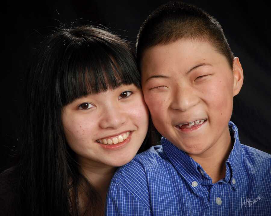 family photo of FASD survivor with adopted sister 