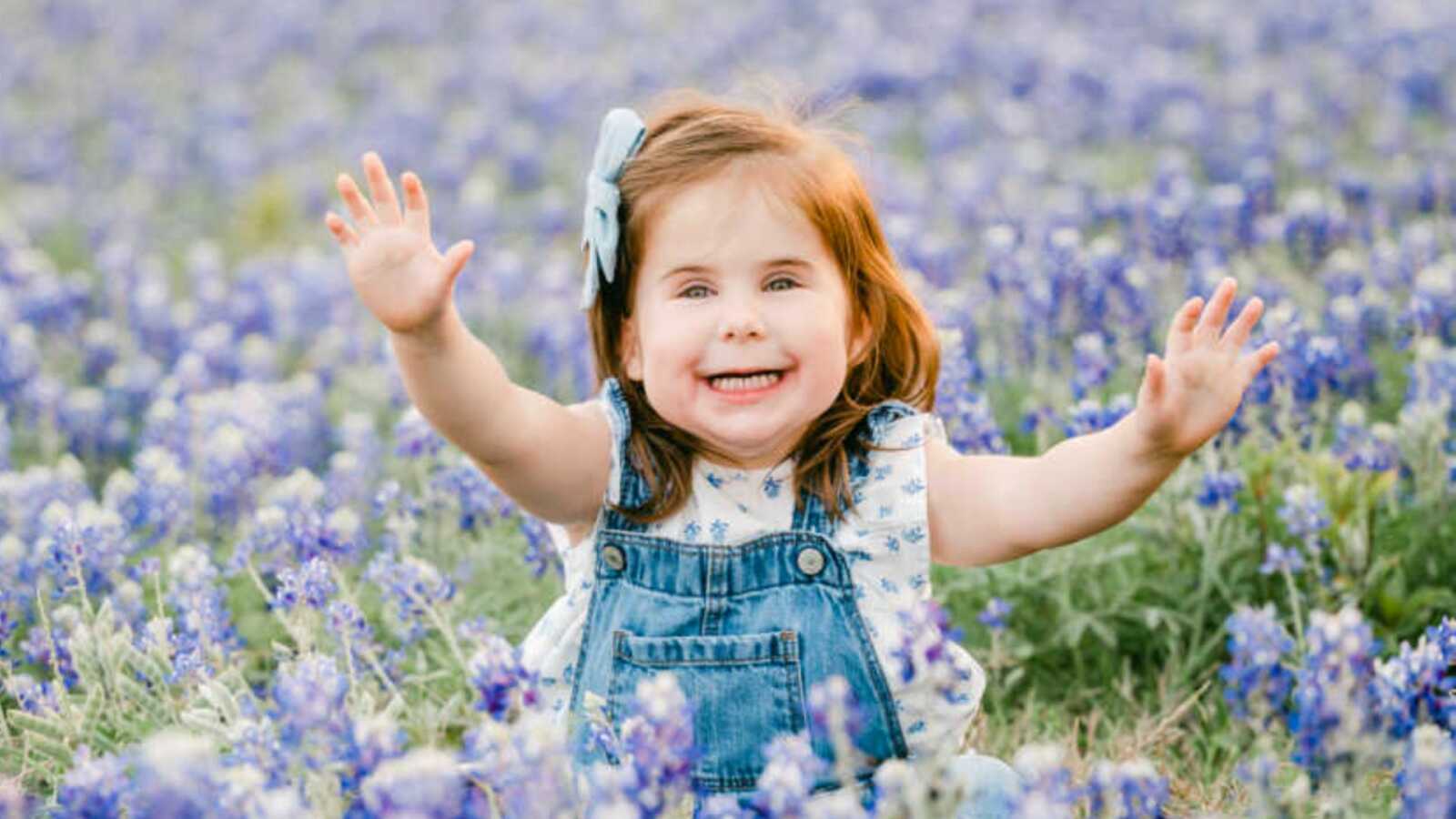 Girl with rare genetic disorder sitting in lavender field