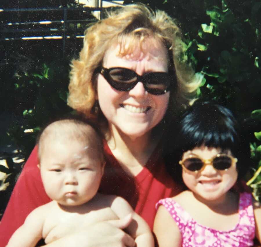 old photo of mother with adopted baby daughter and son with FASD